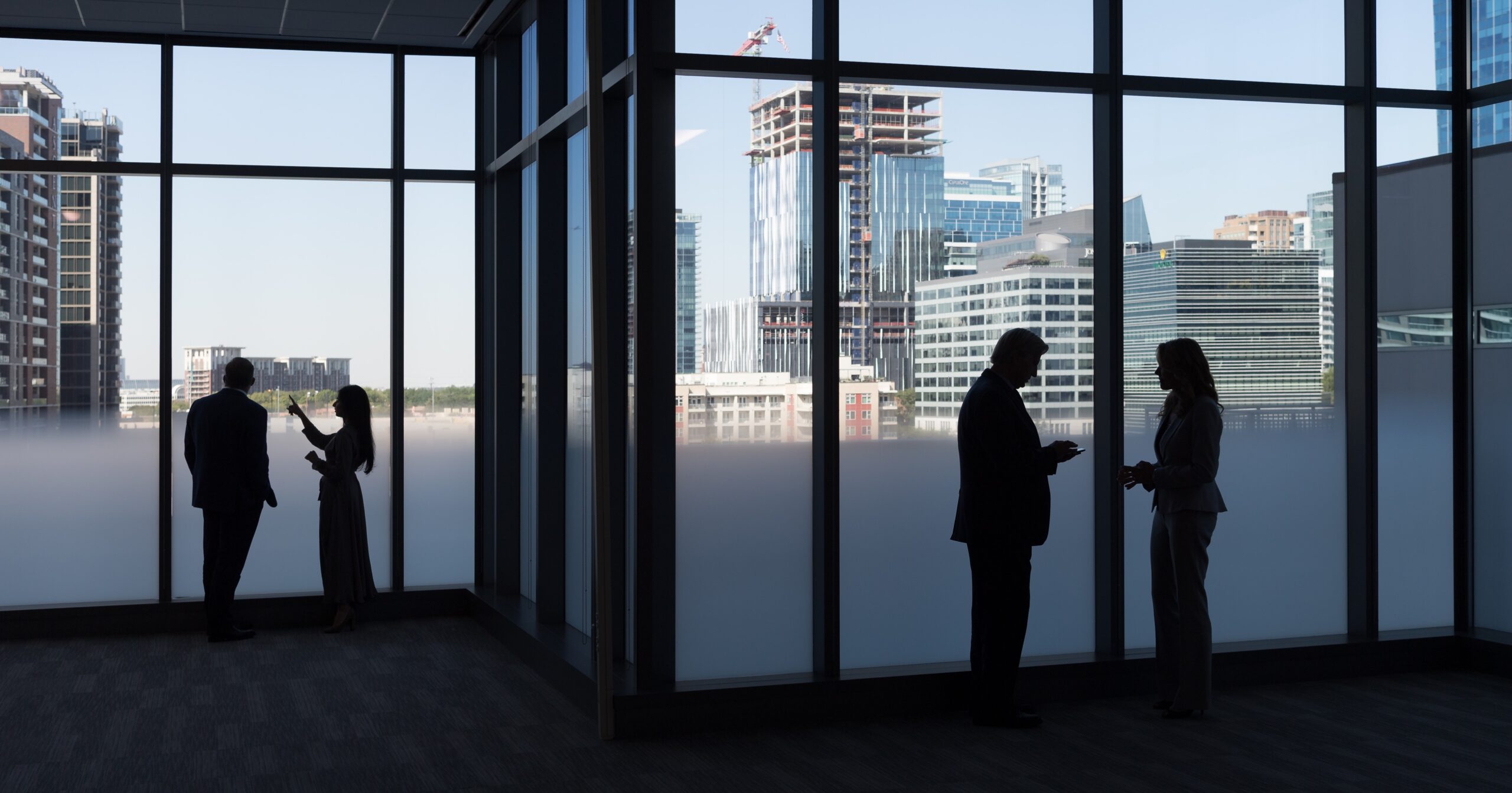 Employees looking out a high rise window